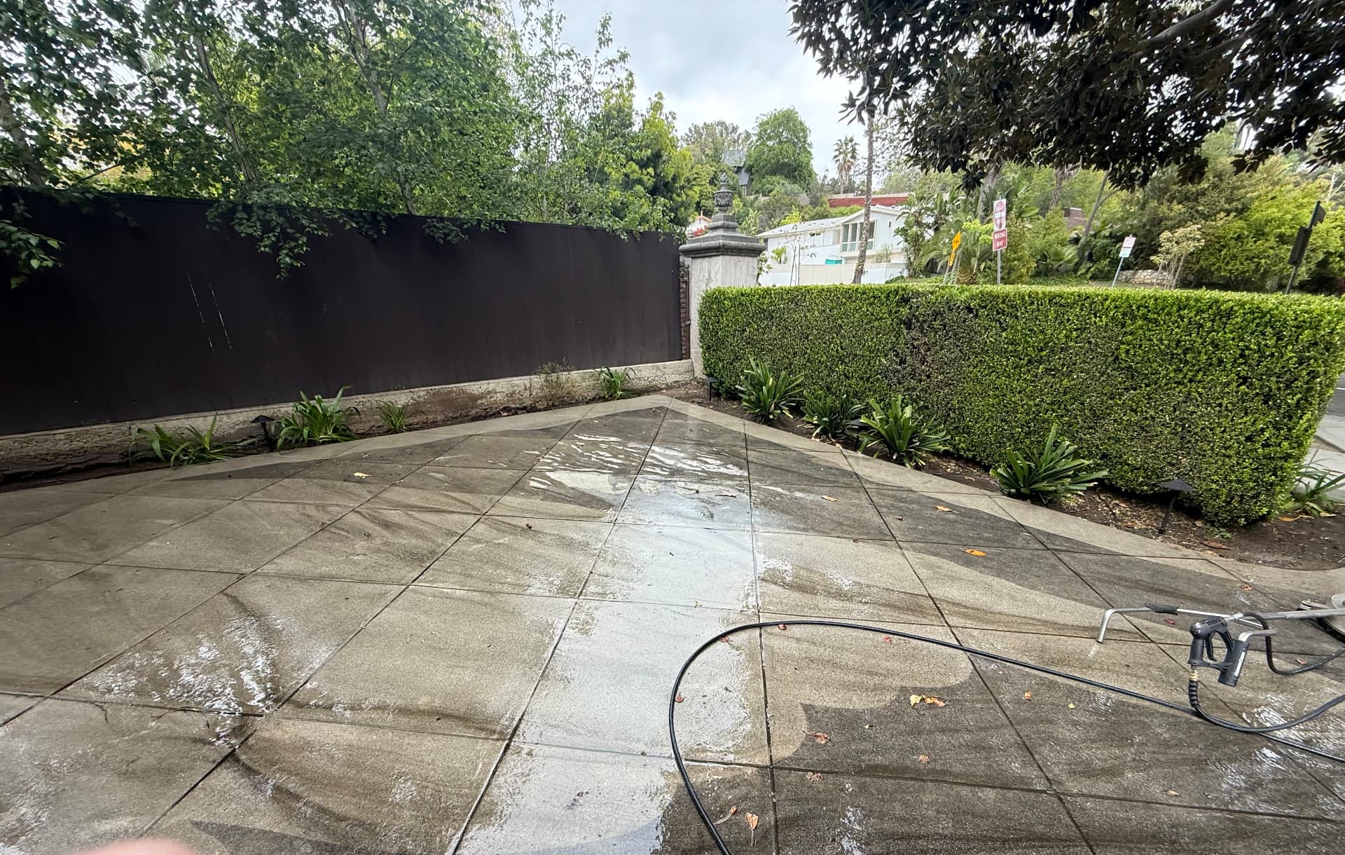 Paver driveway being cleaned with a surface cleaner